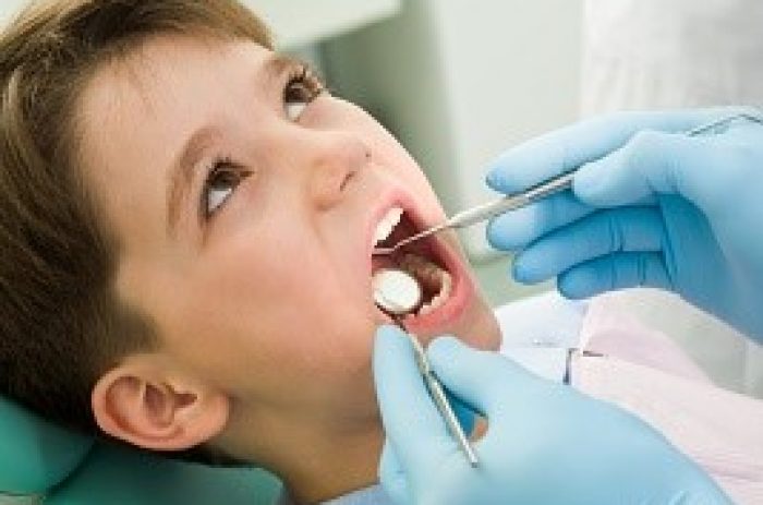 Close-up of little boy opening his mouth during dental checkup